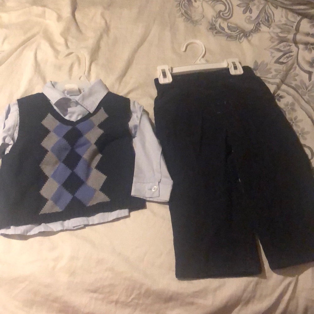 Button up shirt, vest, and corduroy pants.